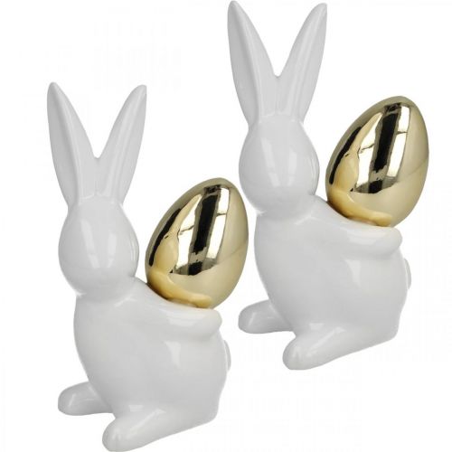 Artikel Konijnen met gouden ei, keramische konijnen voor Pasen nobel wit, gouden H13cm 2st